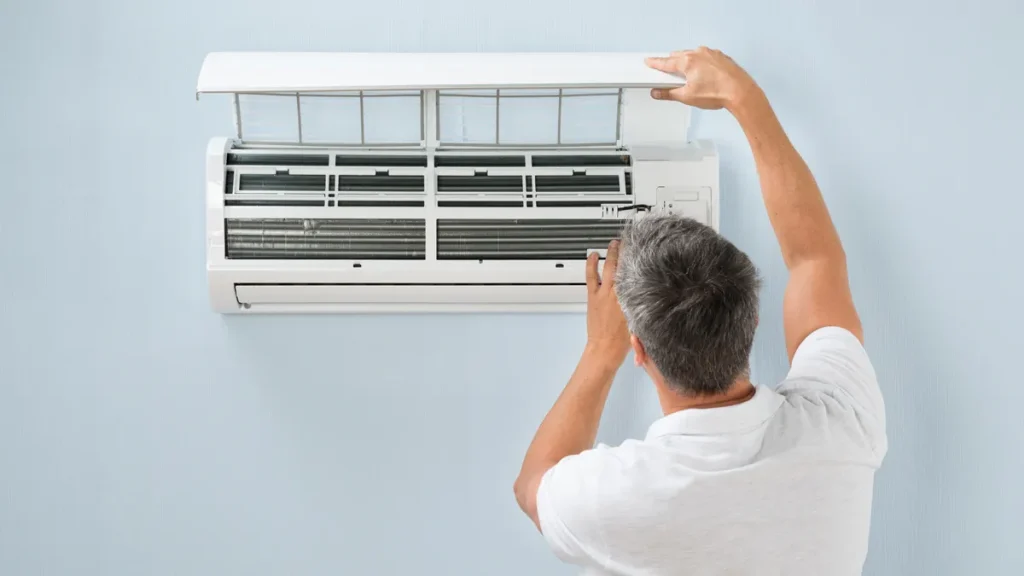 man-cleaning-air-conditioning-filter